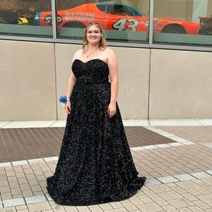 This is a sequin dress, size xl , with a corset back. Has an adhesive on bust.